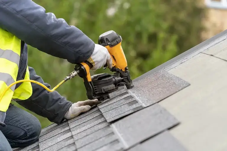 Principal Roofing crew fixing shingles on a roof